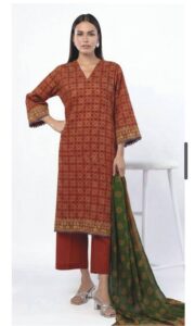 A model wearing a SS2351A 3-piece lawn suit by Khaadi. The outfit features a long kurta with intricate vertical patterns and detailed borders, paired with dyed trousers and a matching printed dupatta with striped and floral designs. The model stands against a plain background, holding the dupatta, with product fabric details displayed on the left side.