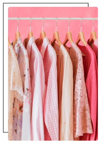 Stylish red dresses and outfits arranged on a clothing rack in a fashion boutique