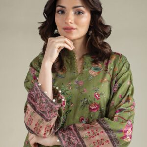 A model wearing a A112-26-101ED2 2-piece lawn suit by Khaadi. The outfit features a long kurta with intricate vertical patterns and detailed borders, paired with dyed trousers and a matching printed dupatta with striped and floral designs. The model stands against a plain background, holding the dupatta, with product fabric details displayed on the left side.