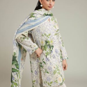 A model wearing a A22-26-103FC1 3-piece lawn suit by Khaadi. The outfit features a long kurta with intricate vertical patterns and detailed borders, paired with dyed trousers and a matching printed dupatta with striped and floral designs. The model stands against a plain background, holding the dupatta, with product fabric details displayed on the left side.