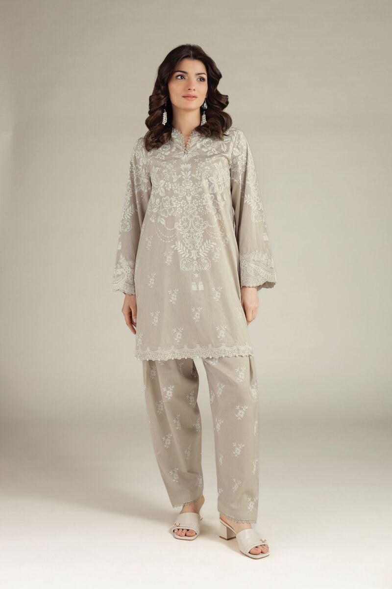 Beige embroidered Pakistani lawn suit for women featuring an elegant floral embroidered kurti with matching straight trousers, perfect for summer wear.